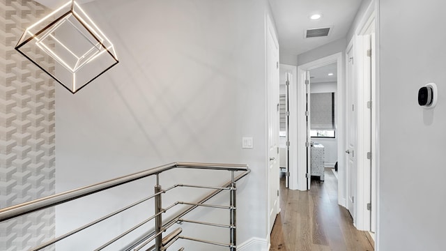 corridor with light hardwood / wood-style floors