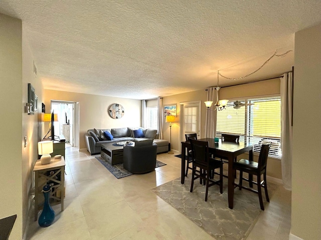 dining space featuring a notable chandelier and a textured ceiling