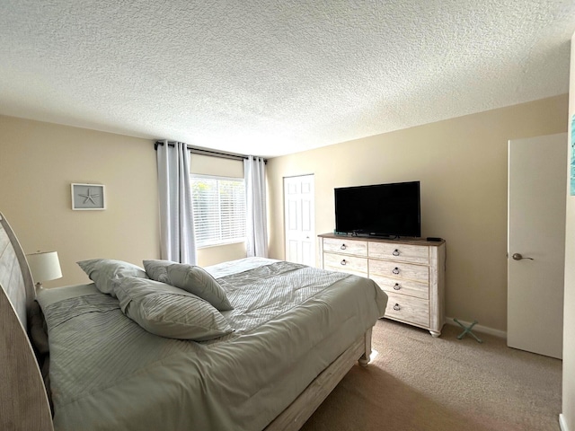 carpeted bedroom featuring a closet and a textured ceiling