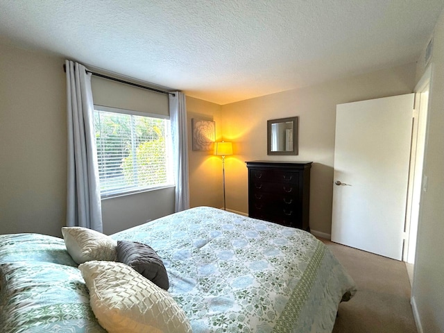 bedroom featuring carpet and a textured ceiling