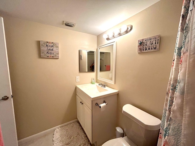 bathroom featuring vanity and toilet