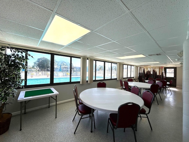 dining space with a paneled ceiling