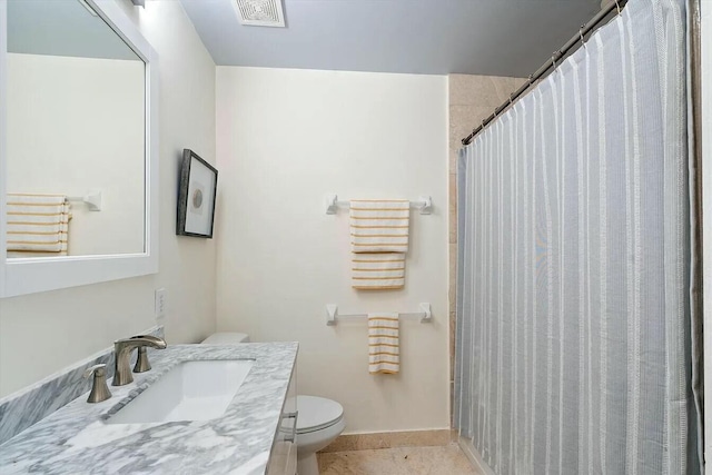 bathroom with vanity, a shower with curtain, tile patterned floors, and toilet