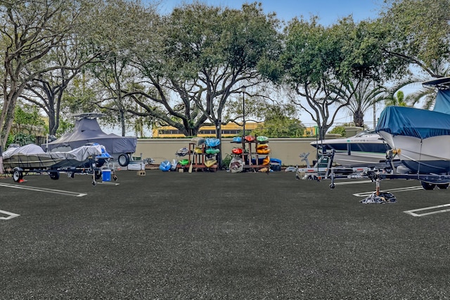 view of car parking featuring a playground