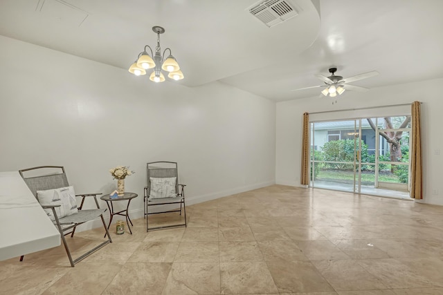 sitting room with ceiling fan with notable chandelier