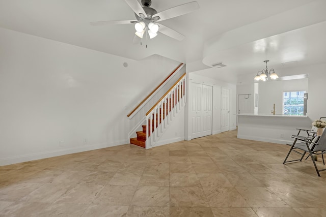 interior space featuring ceiling fan with notable chandelier