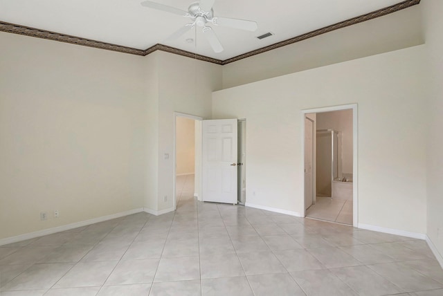 unfurnished room with light tile patterned flooring, ceiling fan, crown molding, and a high ceiling