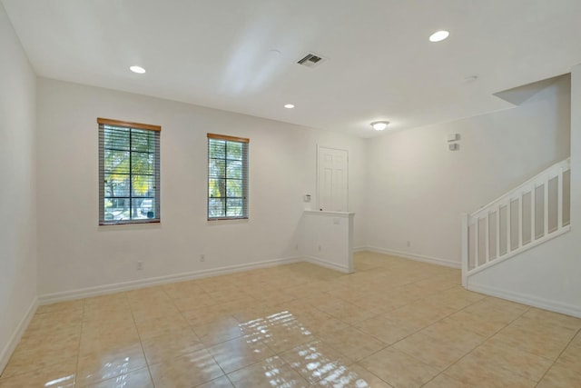 unfurnished room with light tile patterned floors