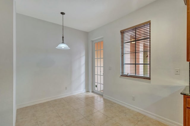 unfurnished dining area with light tile patterned flooring