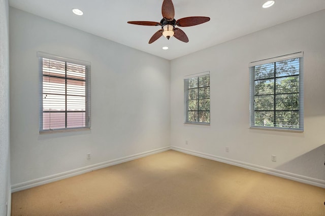 unfurnished room with ceiling fan and carpet flooring