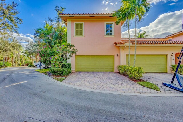 mediterranean / spanish-style house with a garage