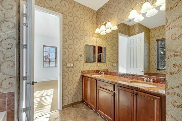 bathroom with vanity, a chandelier, and tile patterned flooring