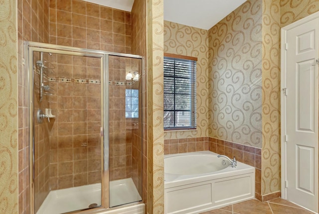 bathroom with tile patterned floors and separate shower and tub