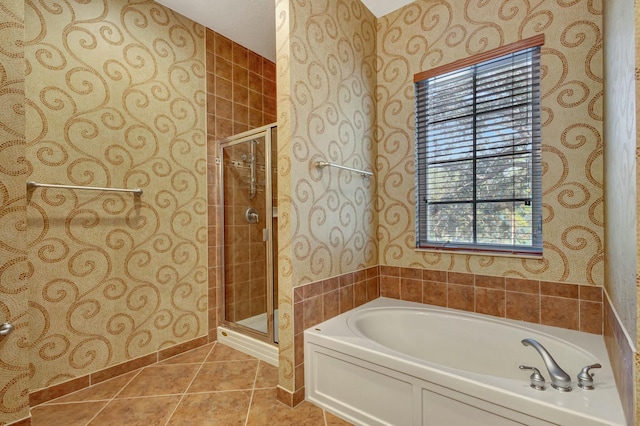 bathroom with tile patterned floors, shower with separate bathtub, and a healthy amount of sunlight