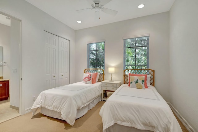 bedroom featuring light carpet, ceiling fan, and a closet