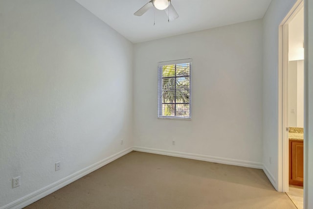 carpeted spare room with ceiling fan