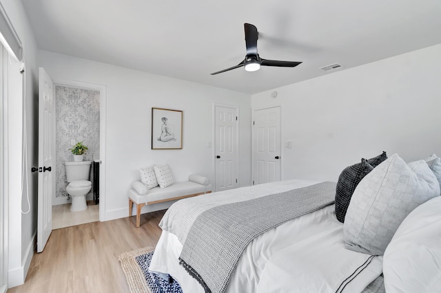 bedroom with ceiling fan, light hardwood / wood-style floors, and ensuite bath