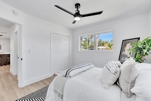 bedroom featuring ceiling fan, a closet, and light wood-type flooring