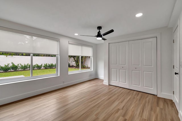 unfurnished bedroom featuring a closet, ceiling fan, and light hardwood / wood-style flooring