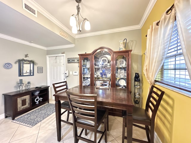 tiled dining room with an inviting chandelier and crown molding