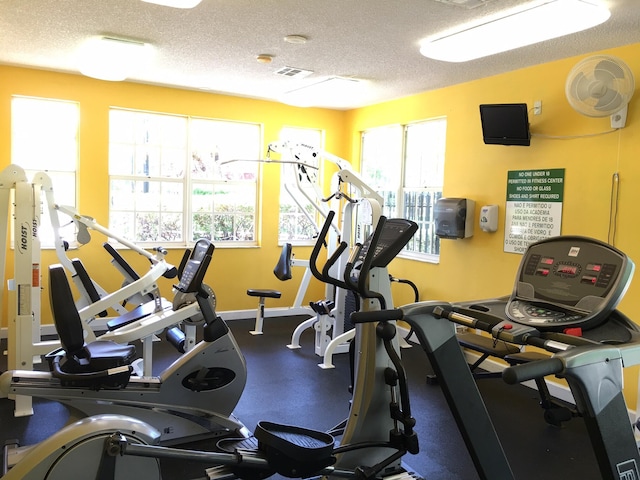 exercise room featuring a textured ceiling