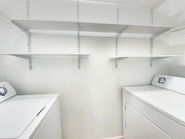 laundry room with washing machine and clothes dryer