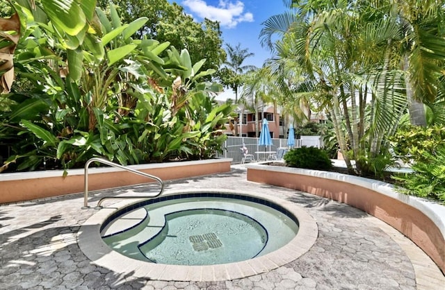 view of swimming pool featuring an in ground hot tub and a patio