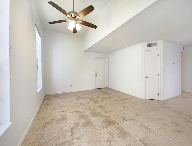 additional living space with a healthy amount of sunlight, light tile patterned floors, and ceiling fan