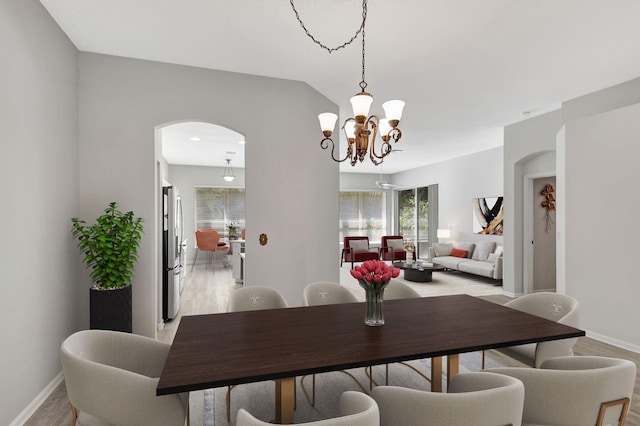 dining area with a notable chandelier and light hardwood / wood-style flooring