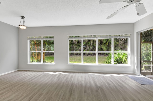 spare room featuring hardwood / wood-style floors, a textured ceiling, and ceiling fan