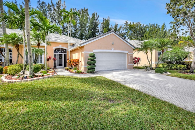 view of front of house featuring a garage and a front lawn