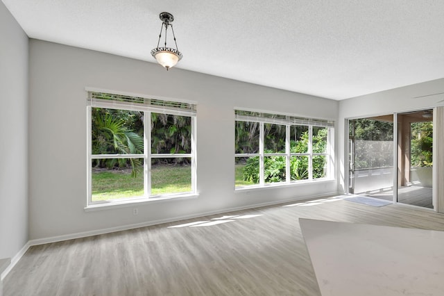 spare room with wood-type flooring and a textured ceiling