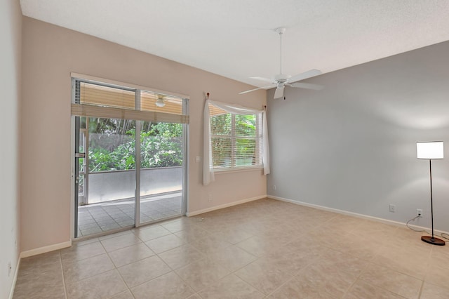 unfurnished room with light tile patterned floors and ceiling fan