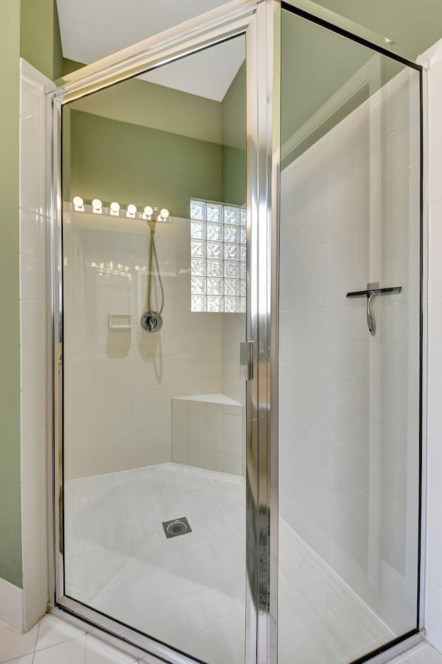 bathroom featuring a shower with shower door