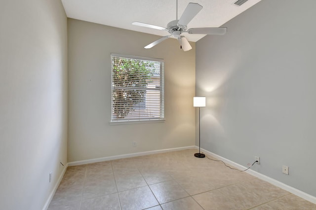 tiled spare room with vaulted ceiling and ceiling fan