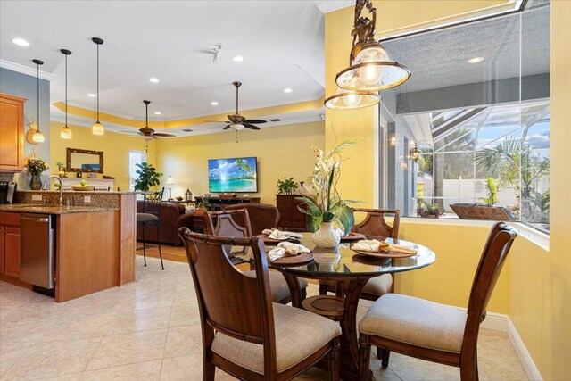 foyer with crown molding, plenty of natural light, and a chandelier