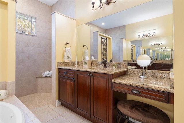 bathroom featuring tile patterned floors, vanity, and a washtub