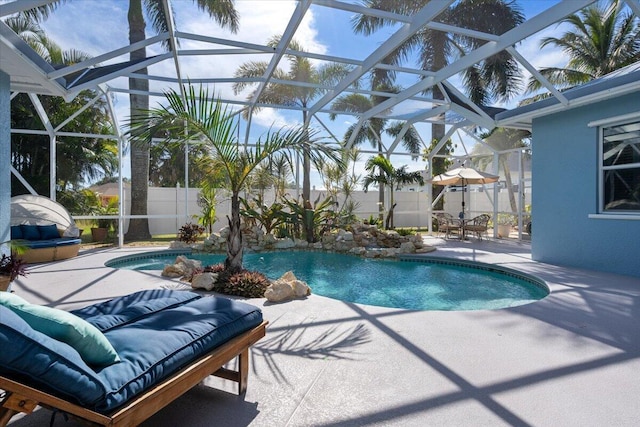 view of swimming pool with glass enclosure, a patio, a fenced in pool, and fence