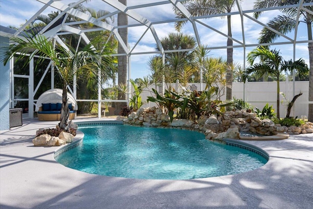 outdoor pool with a patio, fence, and a lanai