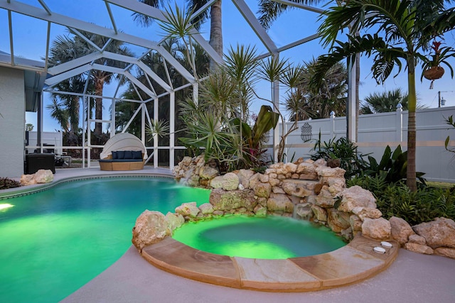 view of swimming pool featuring pool water feature, a lanai, and a patio