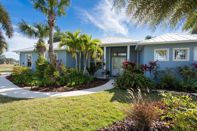 view of front of house with a front yard and french doors