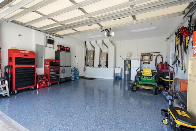 garage with electric panel, a workshop area, a garage door opener, and water heater