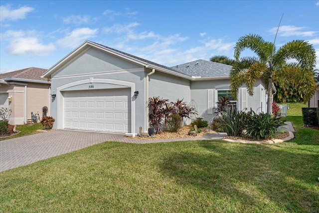 ranch-style home featuring a garage and a front yard