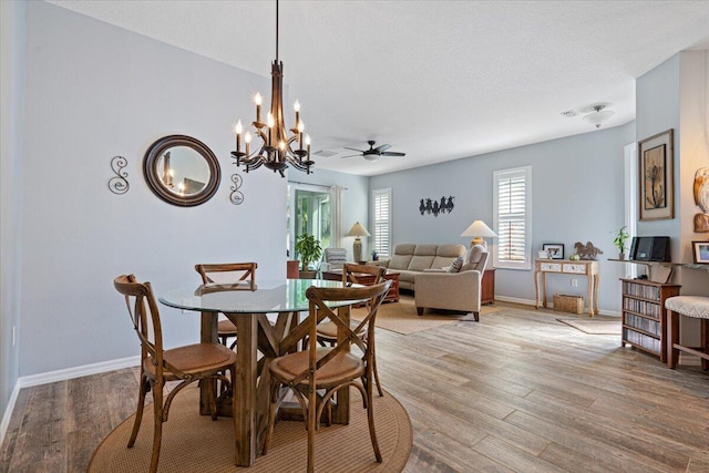 dining room with hardwood / wood-style floors, a textured ceiling, and ceiling fan