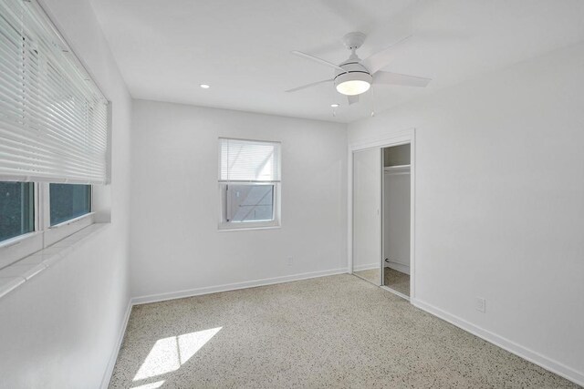 unfurnished bedroom featuring ceiling fan and a closet