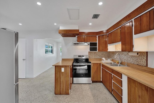 kitchen featuring sink, wooden counters, backsplash, fridge, and stainless steel range with electric cooktop