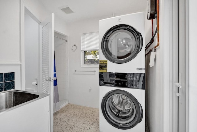 laundry area with stacked washing maching and dryer