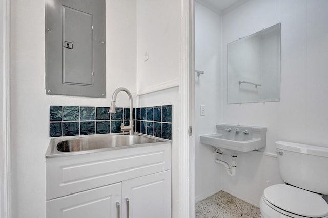 bathroom featuring toilet, electric panel, sink, and backsplash