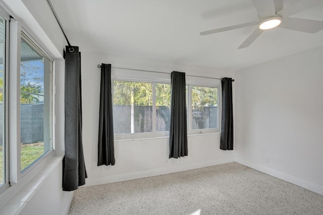 empty room with a wealth of natural light and ceiling fan