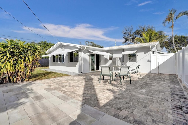 rear view of property featuring a patio